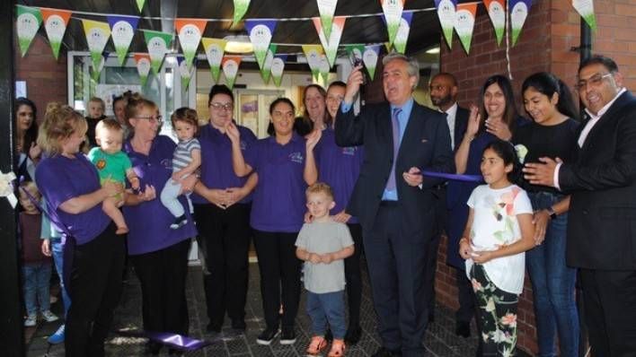 Raj and Jyoti Jaspal with staff and children from Little Folks Nursery with Mark Garnier MP